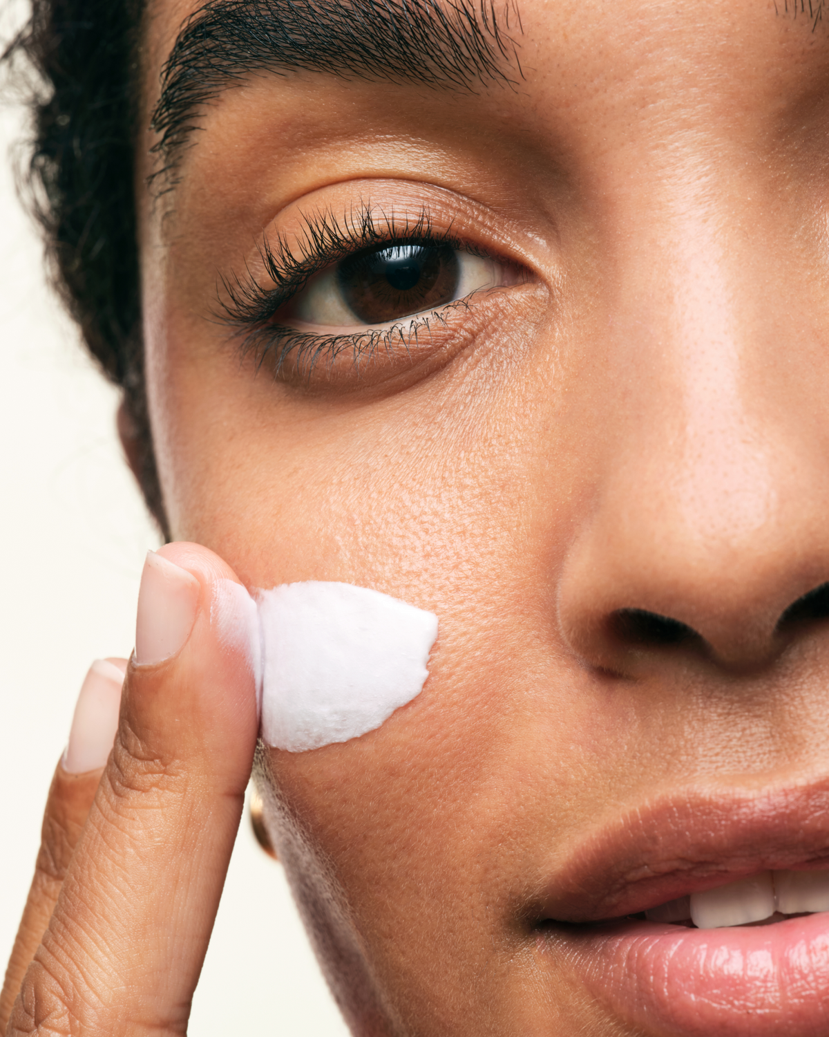 Person applying Skinfix Ceramide Prime Whipped Cream to cheek