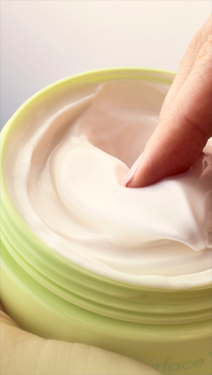 Hand dipping into jar of Skinfix AHA/BHA Renewing Cream